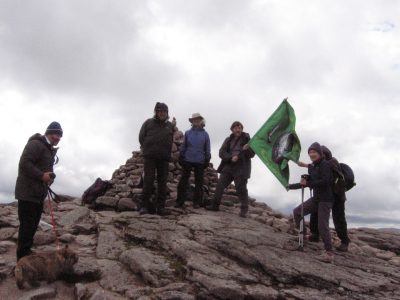 Unfurliing the banner at the summit of Cairngorm